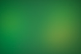 a blurry green background with a white border