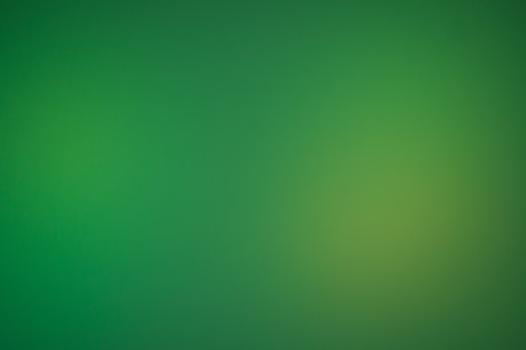 a blurry green background with a white border