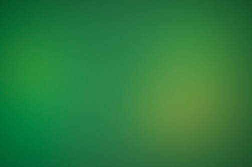 a blurry green background with a white border
