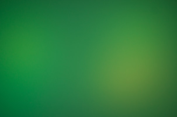 a blurry green background with a white border