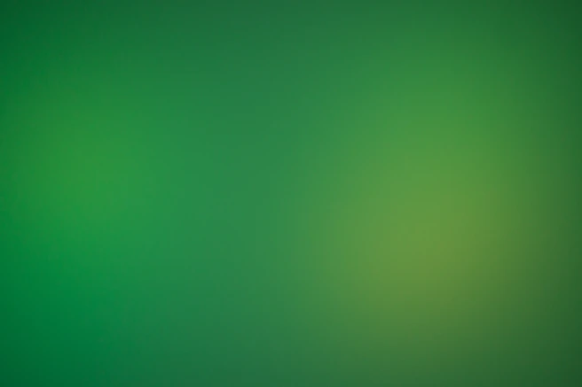 a blurry green background with a white border