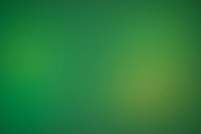 a blurry green background with a white border