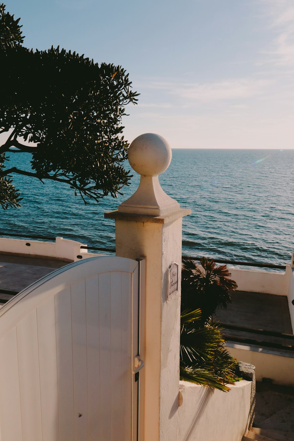 a view of the ocean from behind a gate