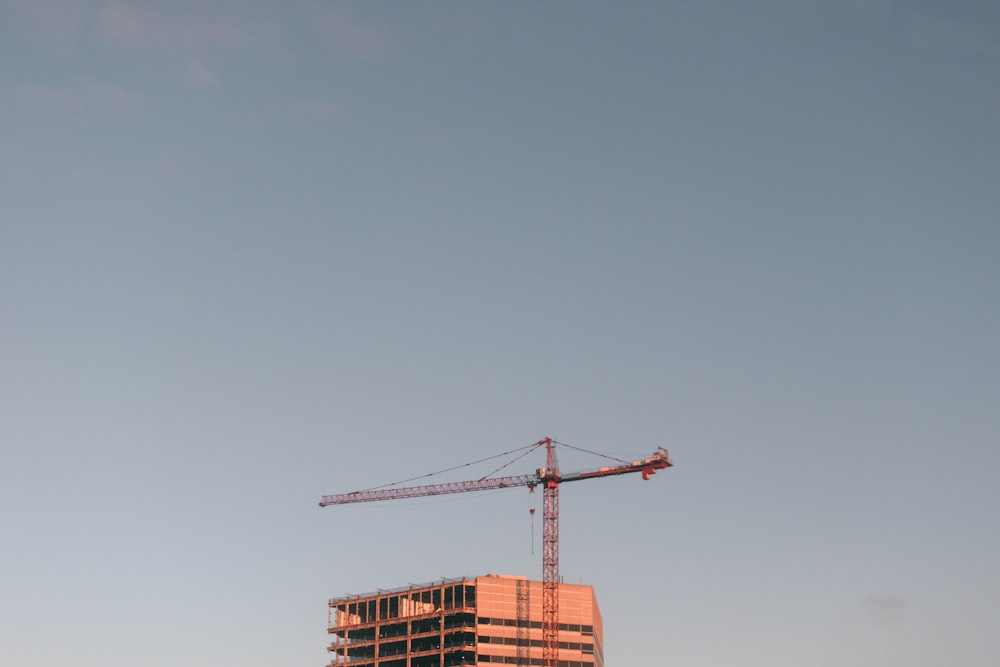 a crane on top of a building under a blue sky