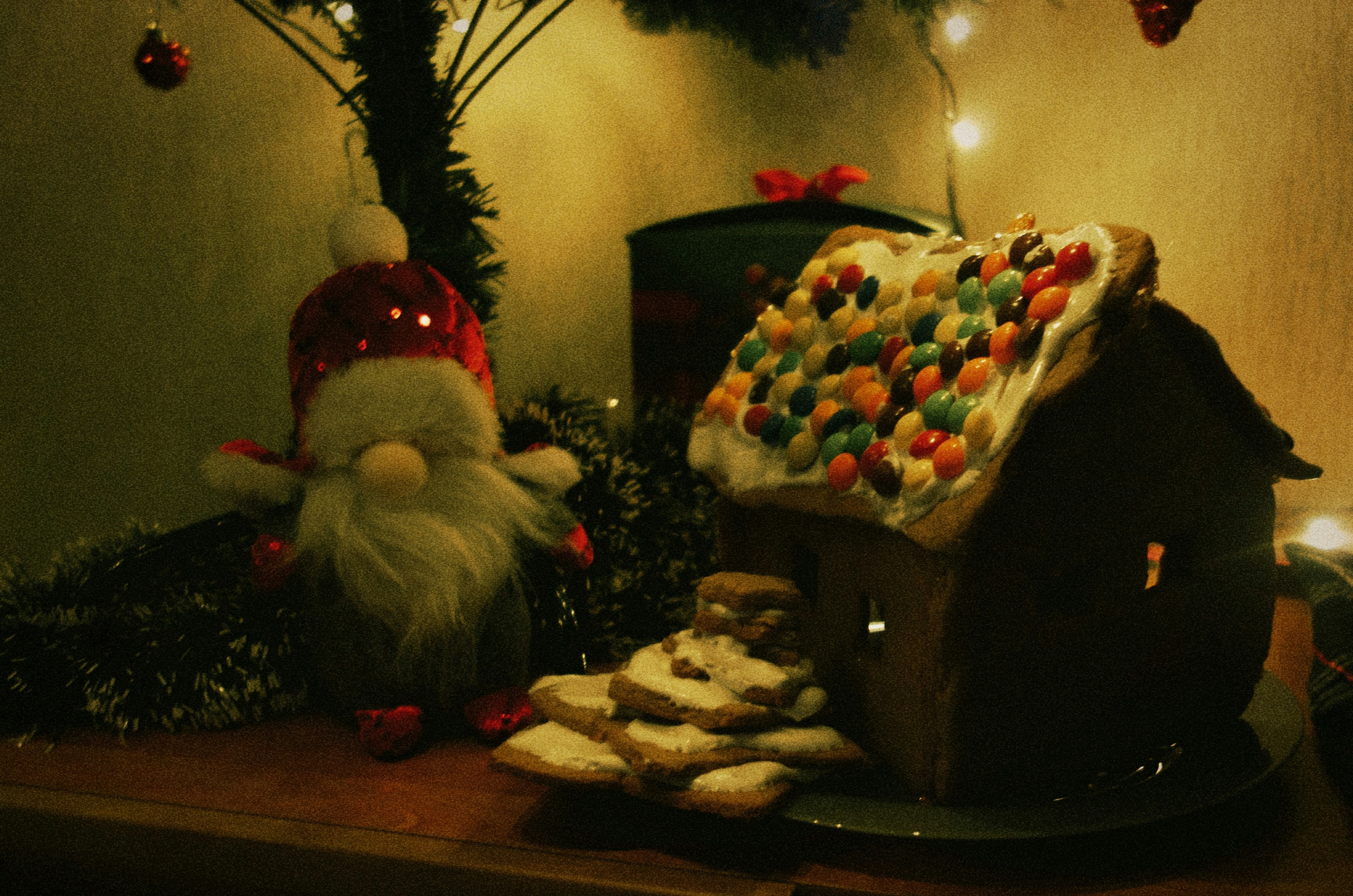 a gingerbread house with a gnome next to it
