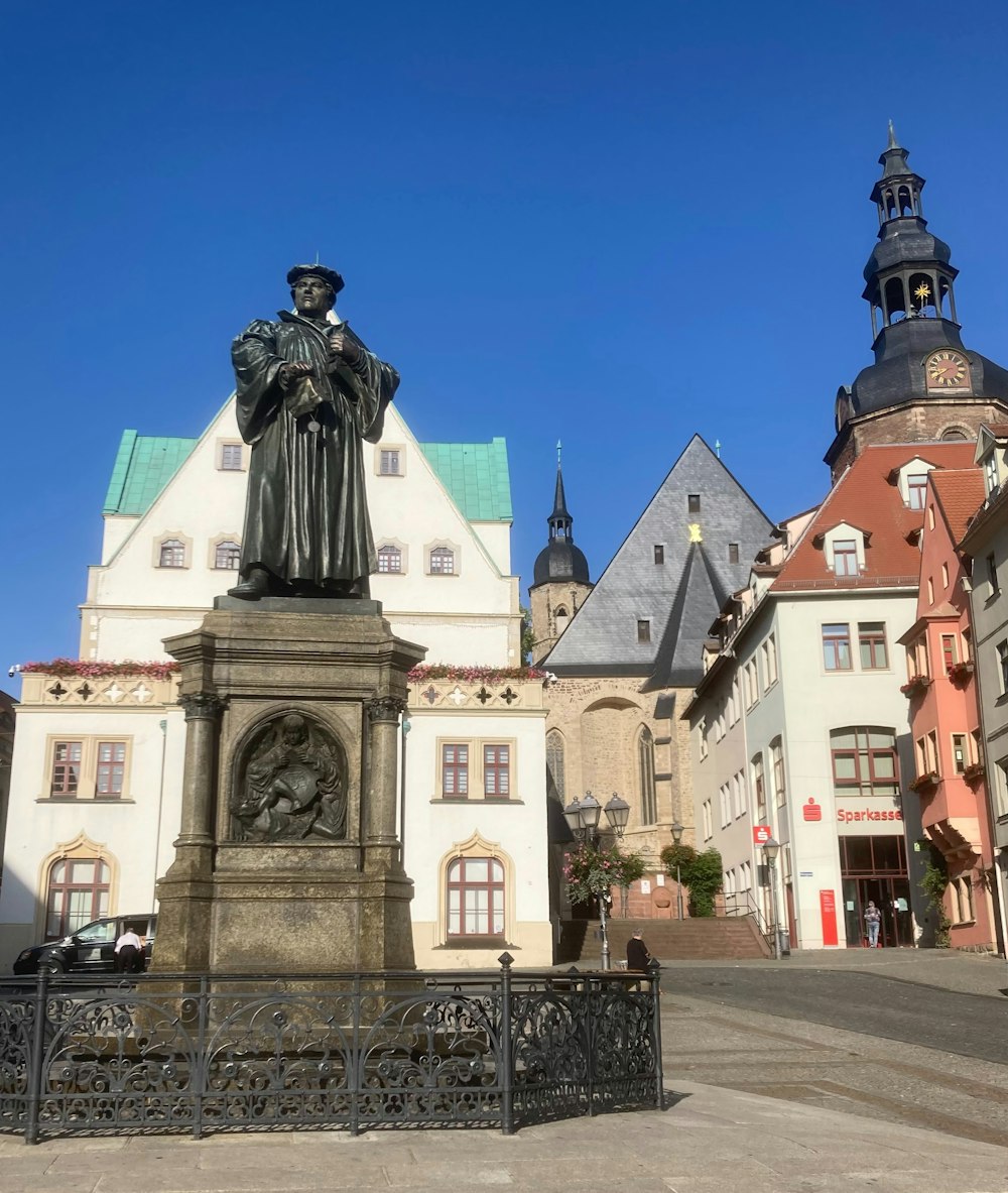 a statue of a man in front of a building