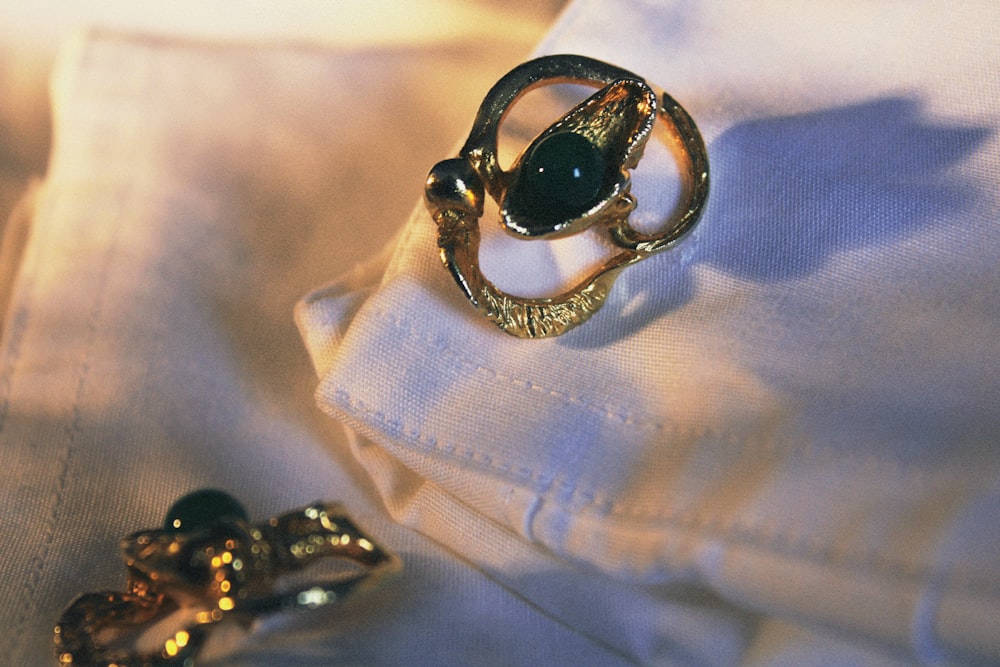 a pair of rings sitting on top of a white shirt