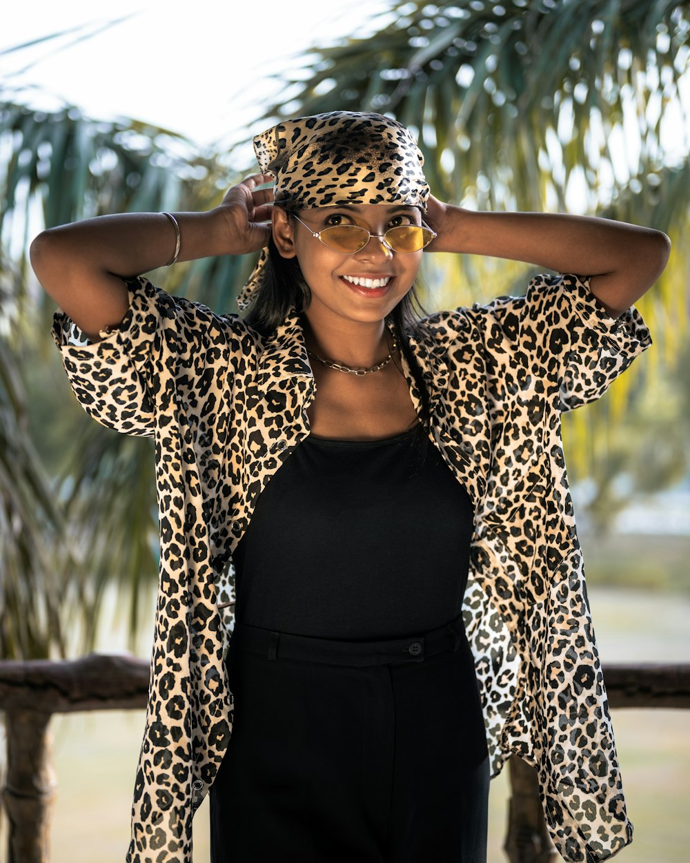 a woman in a black top and a leopard print jacket