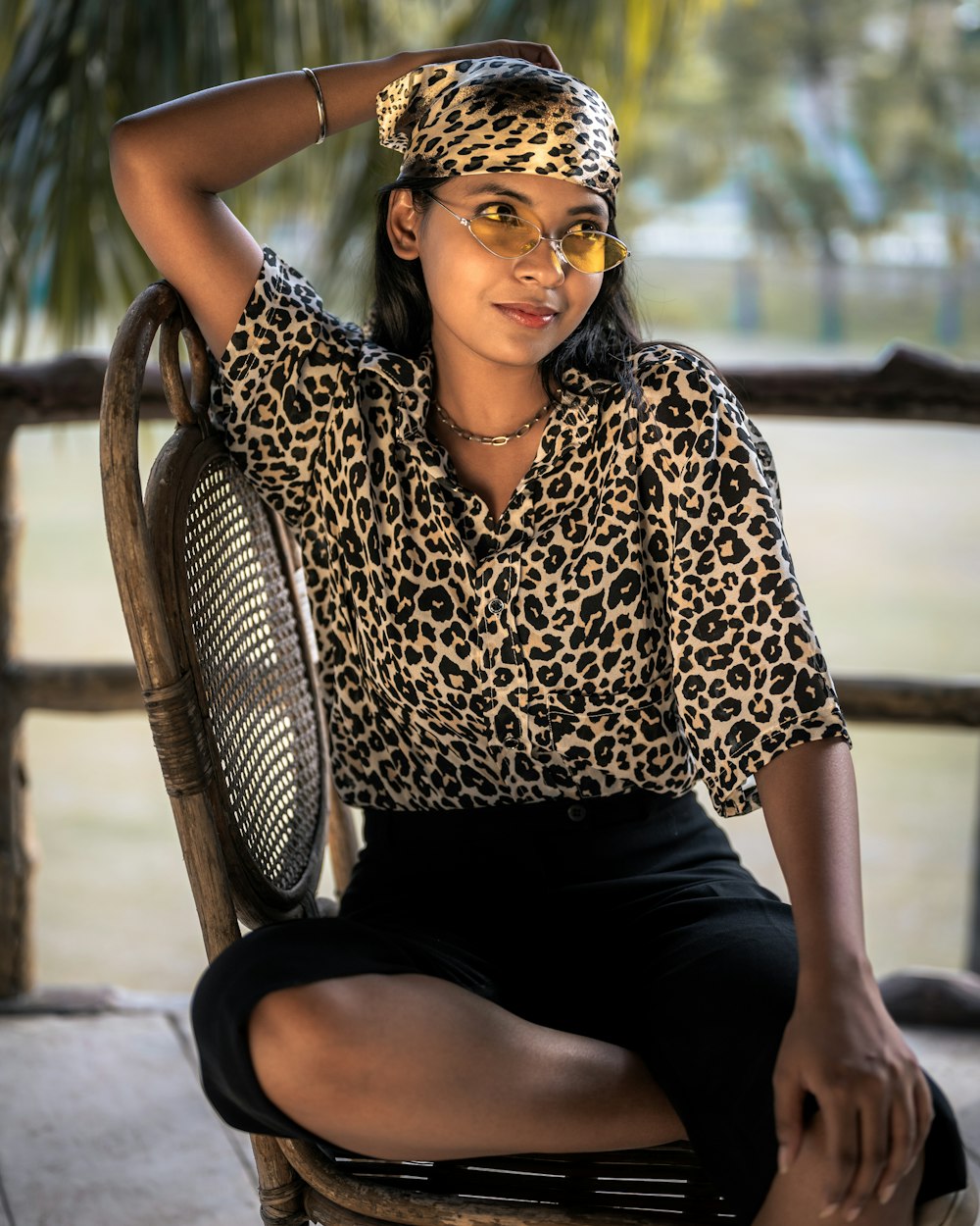 a woman sitting on a chair with a tennis racket