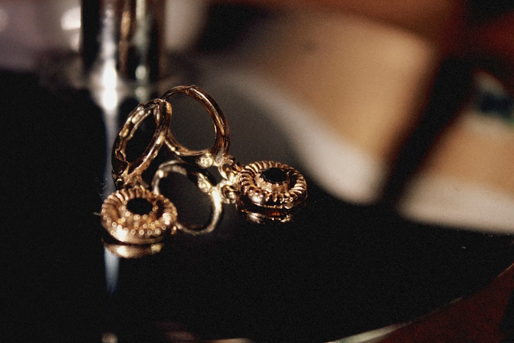 a pair of gold rings sitting on top of a table