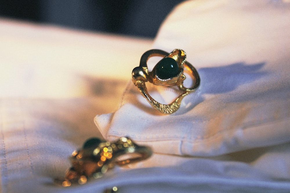 a couple of rings sitting on top of a white pillow