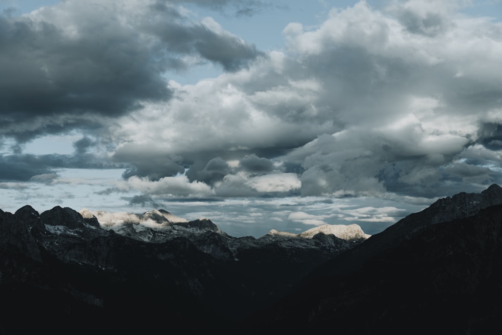 a view of a mountain range with clouds in the sky