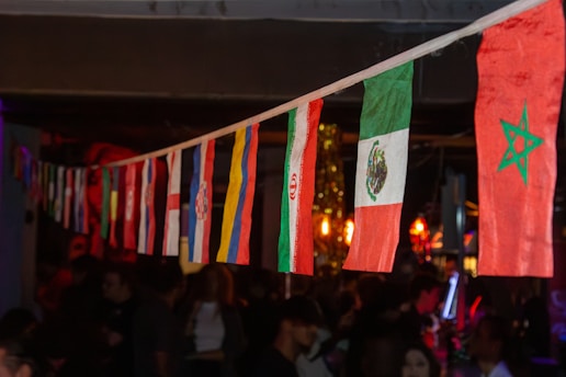 a group of flags hanging from a ceiling