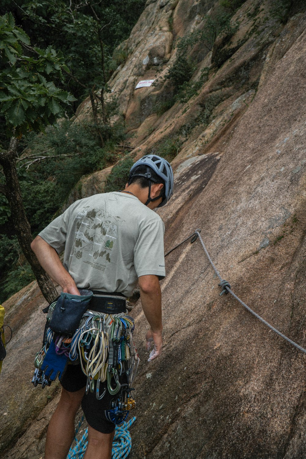 a man climbing up the side of a mountain