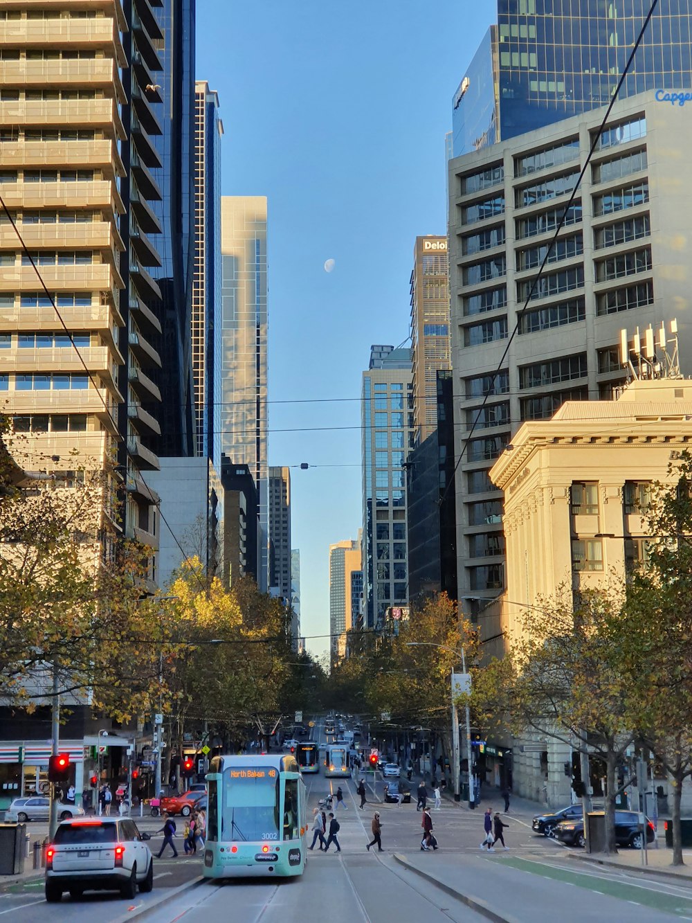 a city street filled with lots of traffic and tall buildings