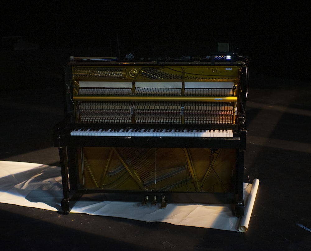 a piano sitting on top of a white sheet