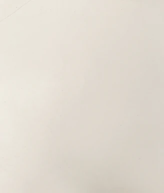 A smooth off-white surface with a subtle matte texture
