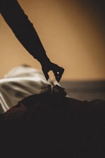 a person reaching for something on a bed