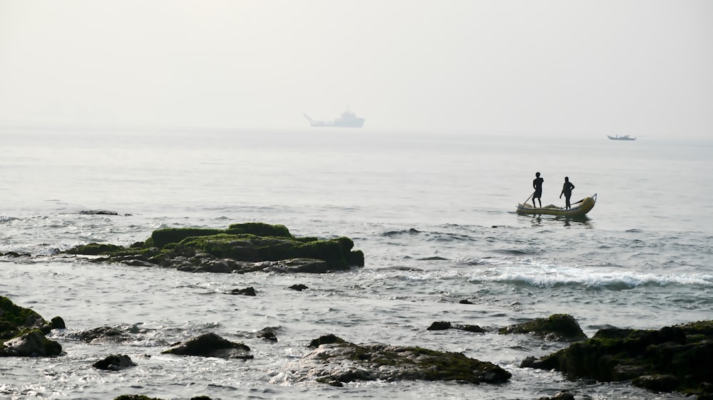 two people in a small boat in the ocean