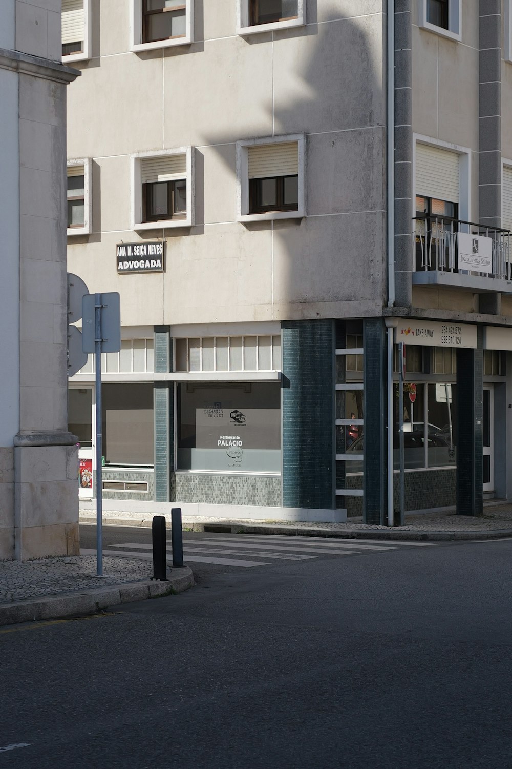 a street corner with a building and a street sign