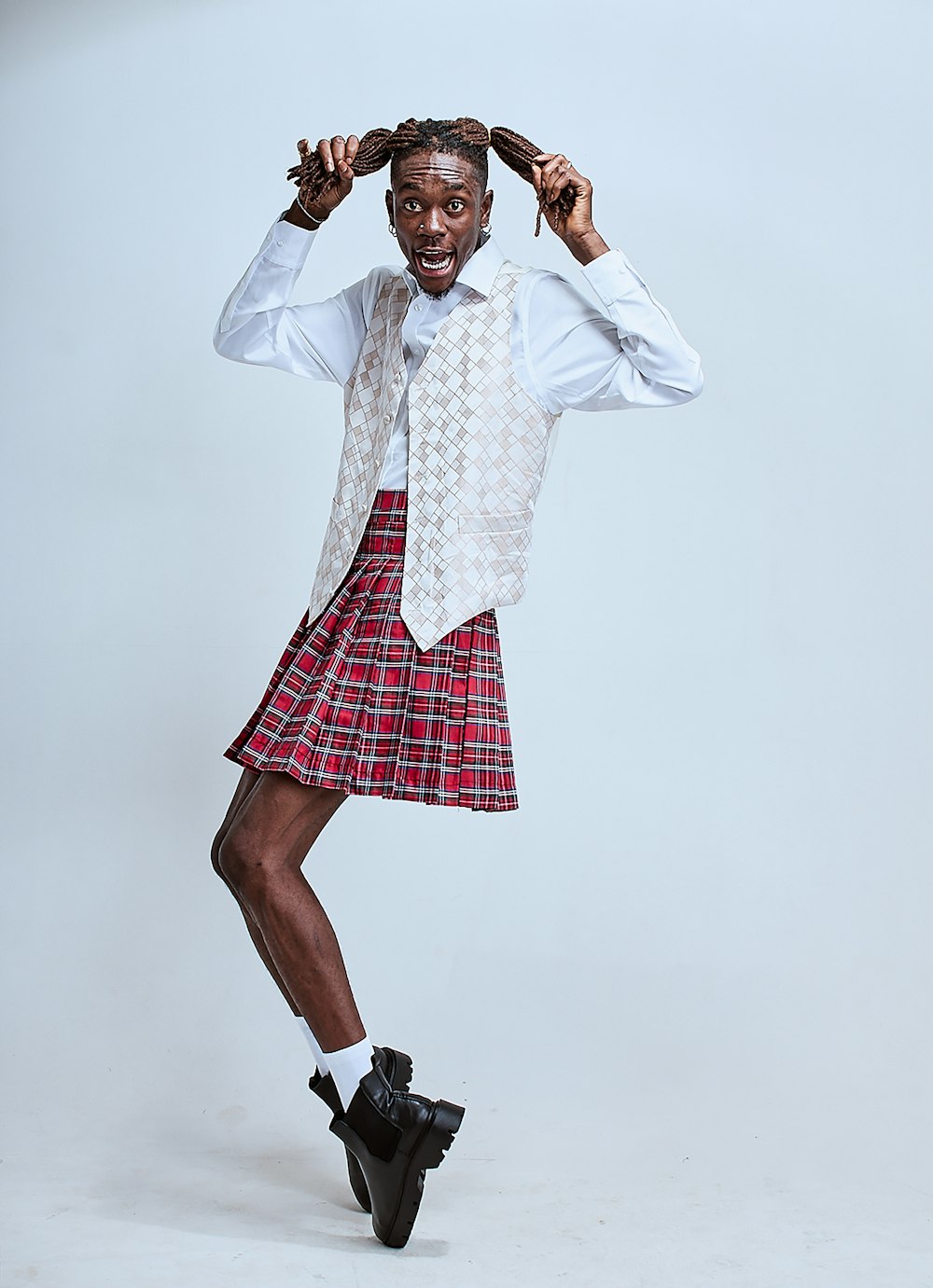 a man in a kilt is posing for a picture