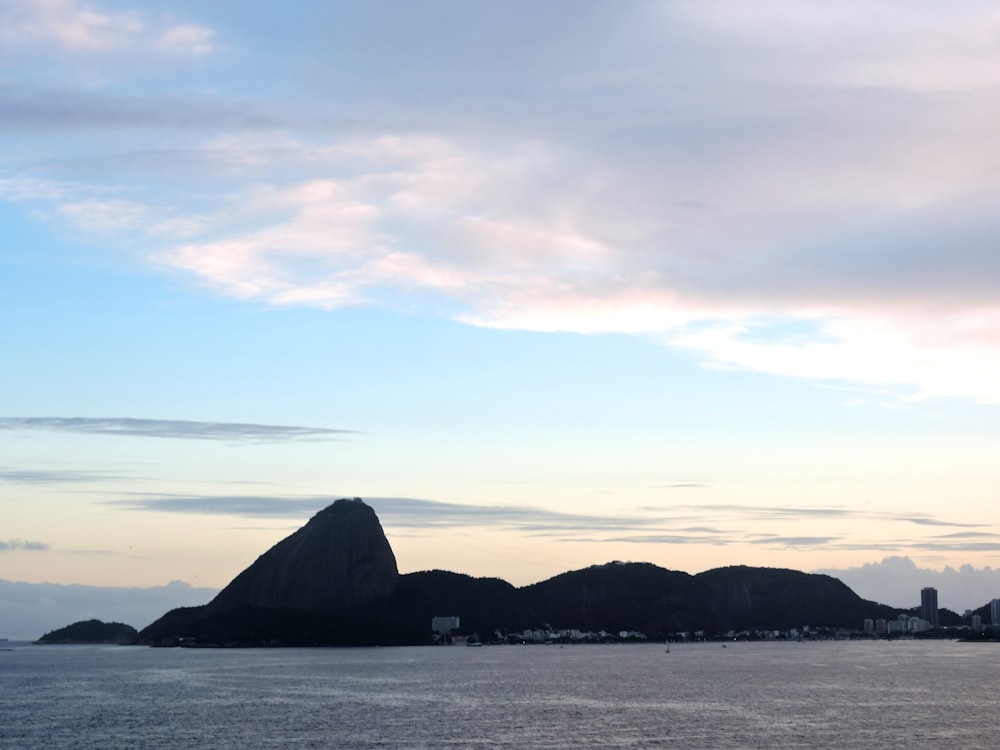 a body of water with a mountain in the background