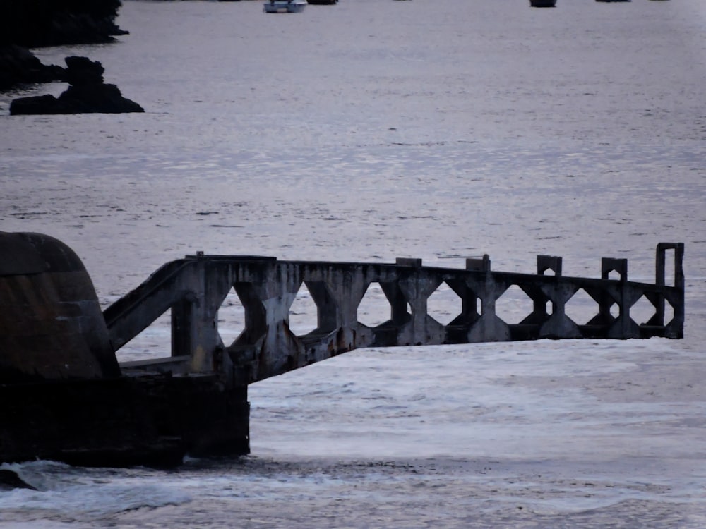 a rusty bridge over a body of water