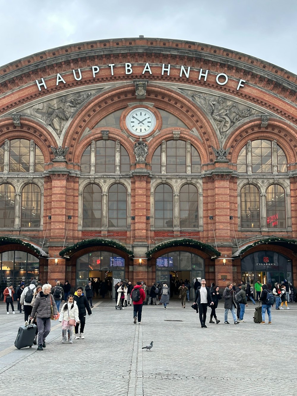 a group of people standing in front of a train station