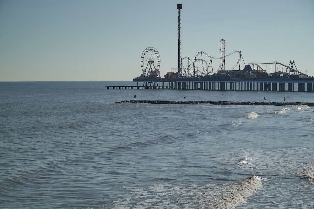 a pier with a ferris wheel in the background