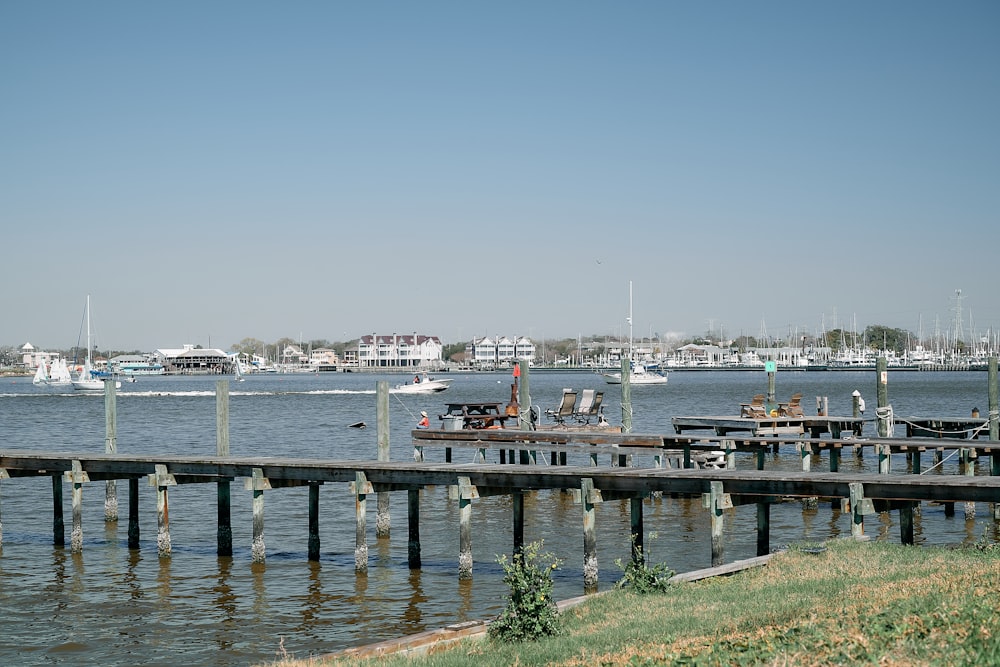 a dock with boats in the water and a sky background