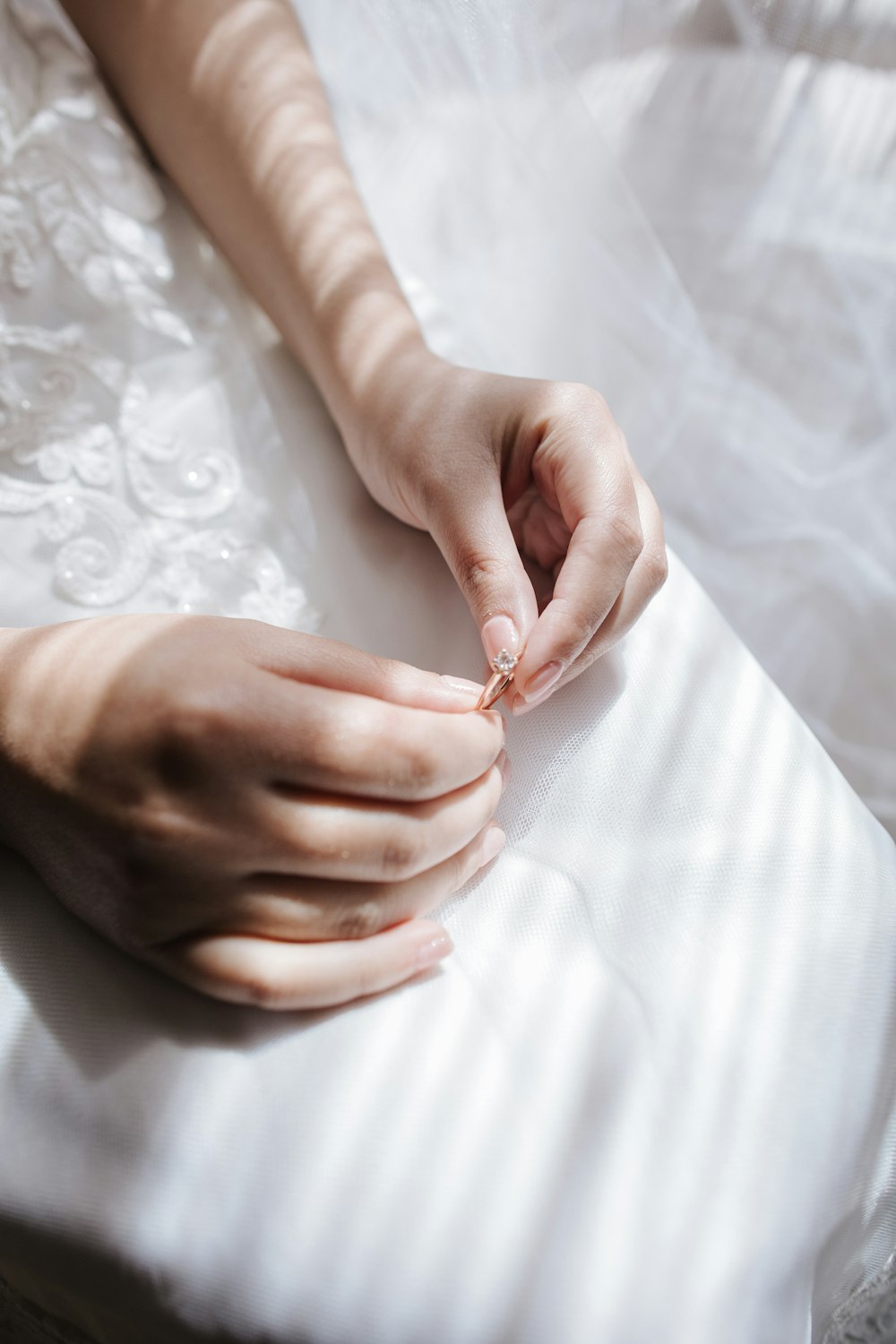 a woman's hands on top of a white sheet