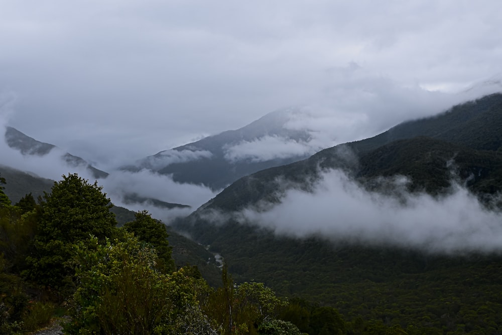 a view of a mountain range covered in clouds