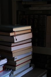 a stack of books sitting on top of a table