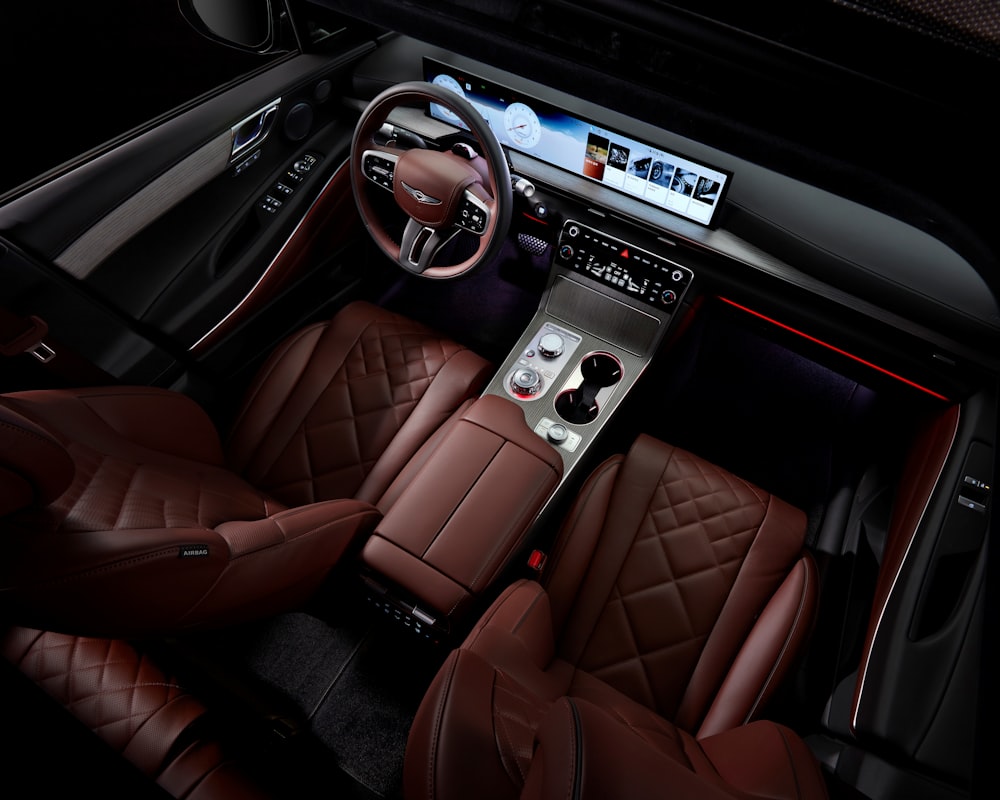 the interior of a car with brown leather seats