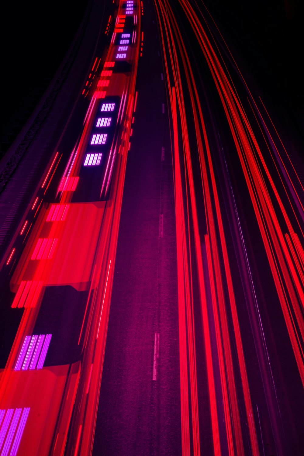 a red and purple photo of a train track