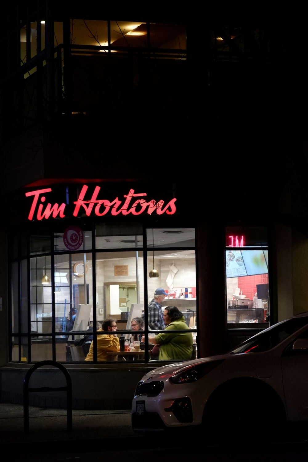 a couple of cars parked in front of a store