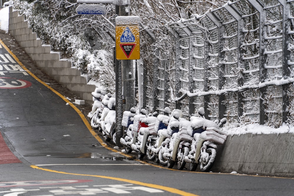 a row of parked motorcycles next to a street