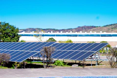 a row of solar panels sitting next to a swimming pool