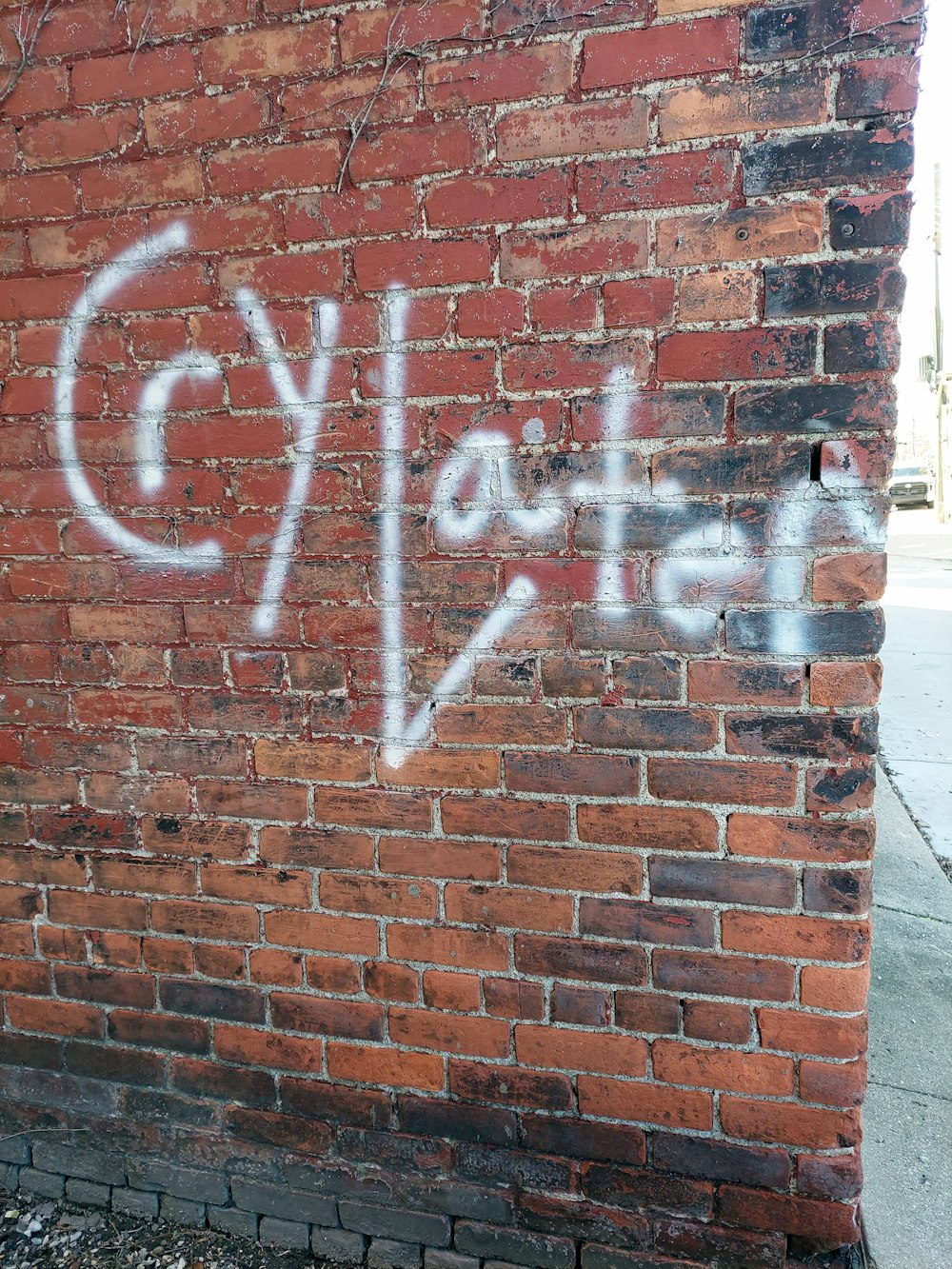 a brick wall with graffiti written on it