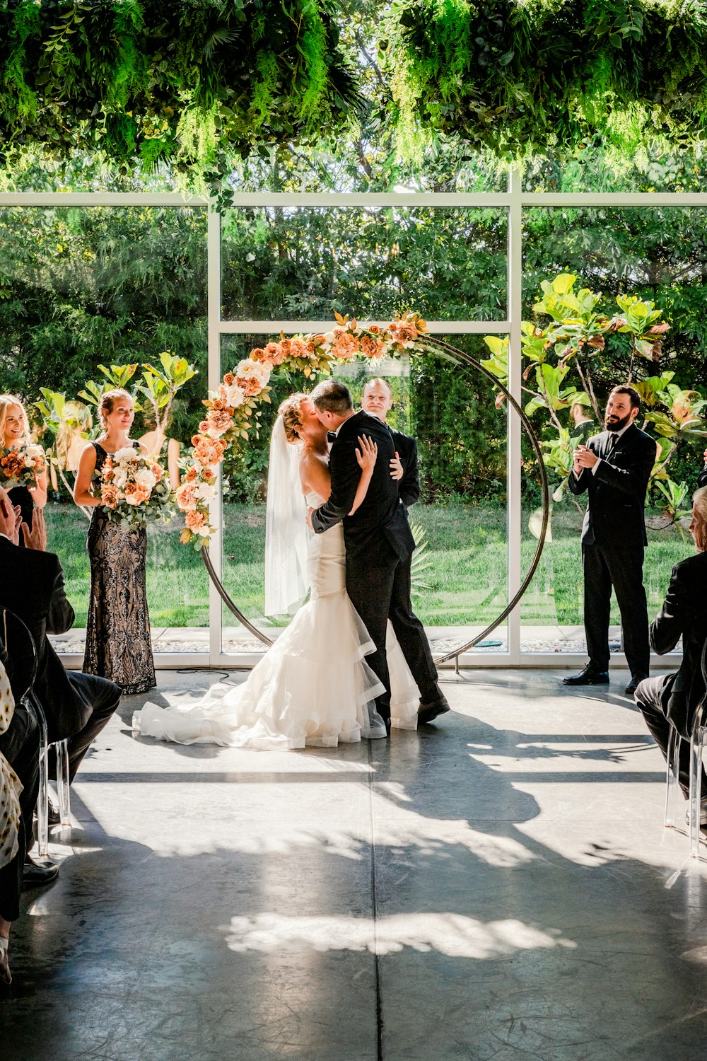 a bride and groom kissing in front of an outdoor ceremony