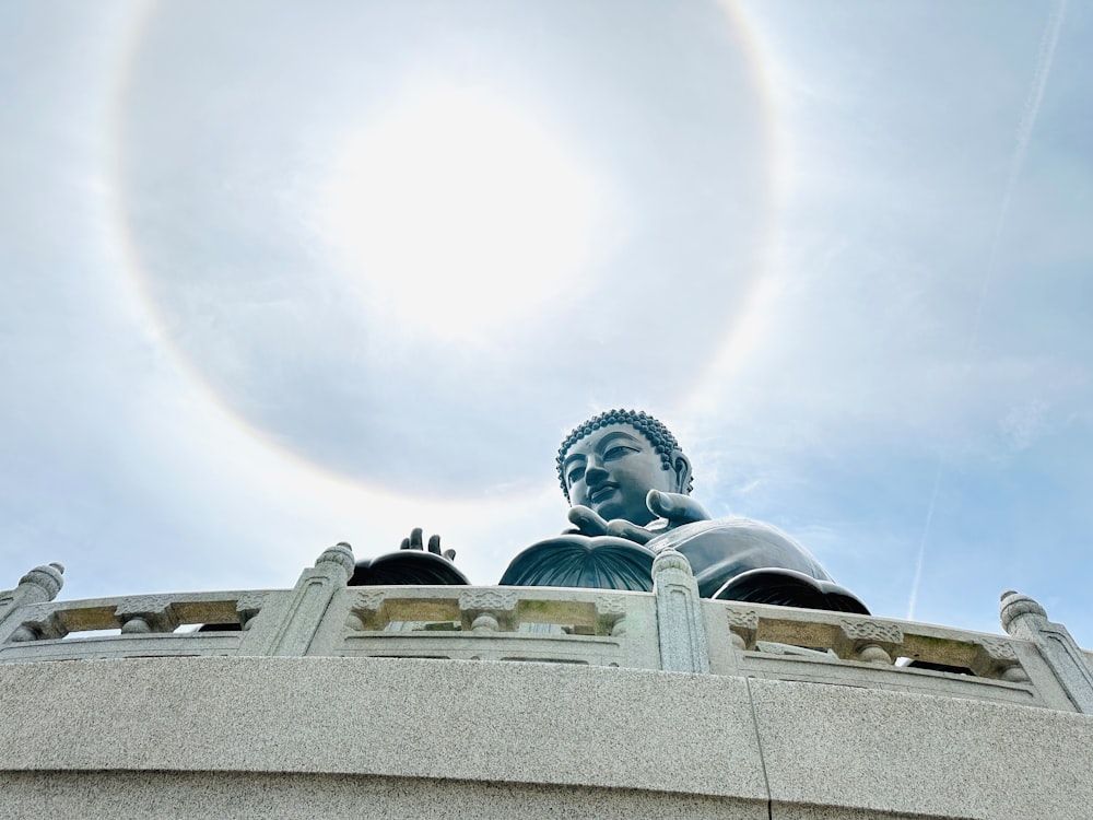 a statue of a buddha with a halo around it