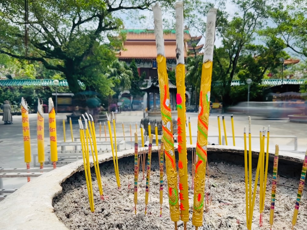 a group of yellow and orange poles in a circle