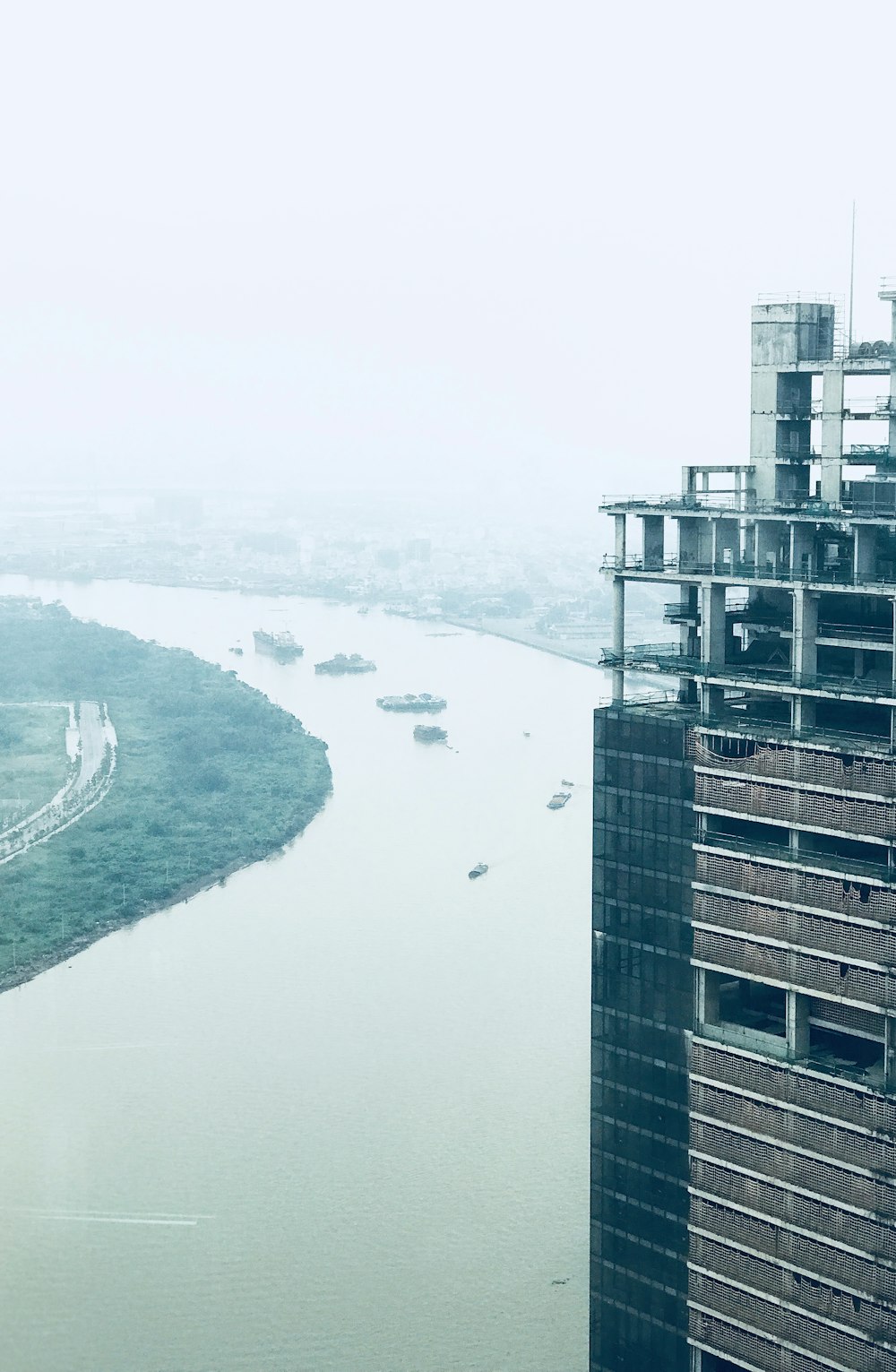 a very tall building next to a body of water