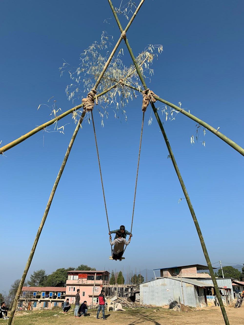 a man on a swing in the middle of a field