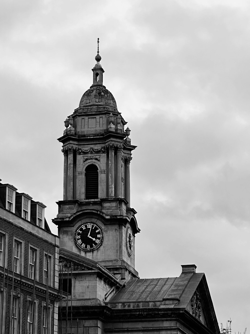 a black and white photo of a clock tower