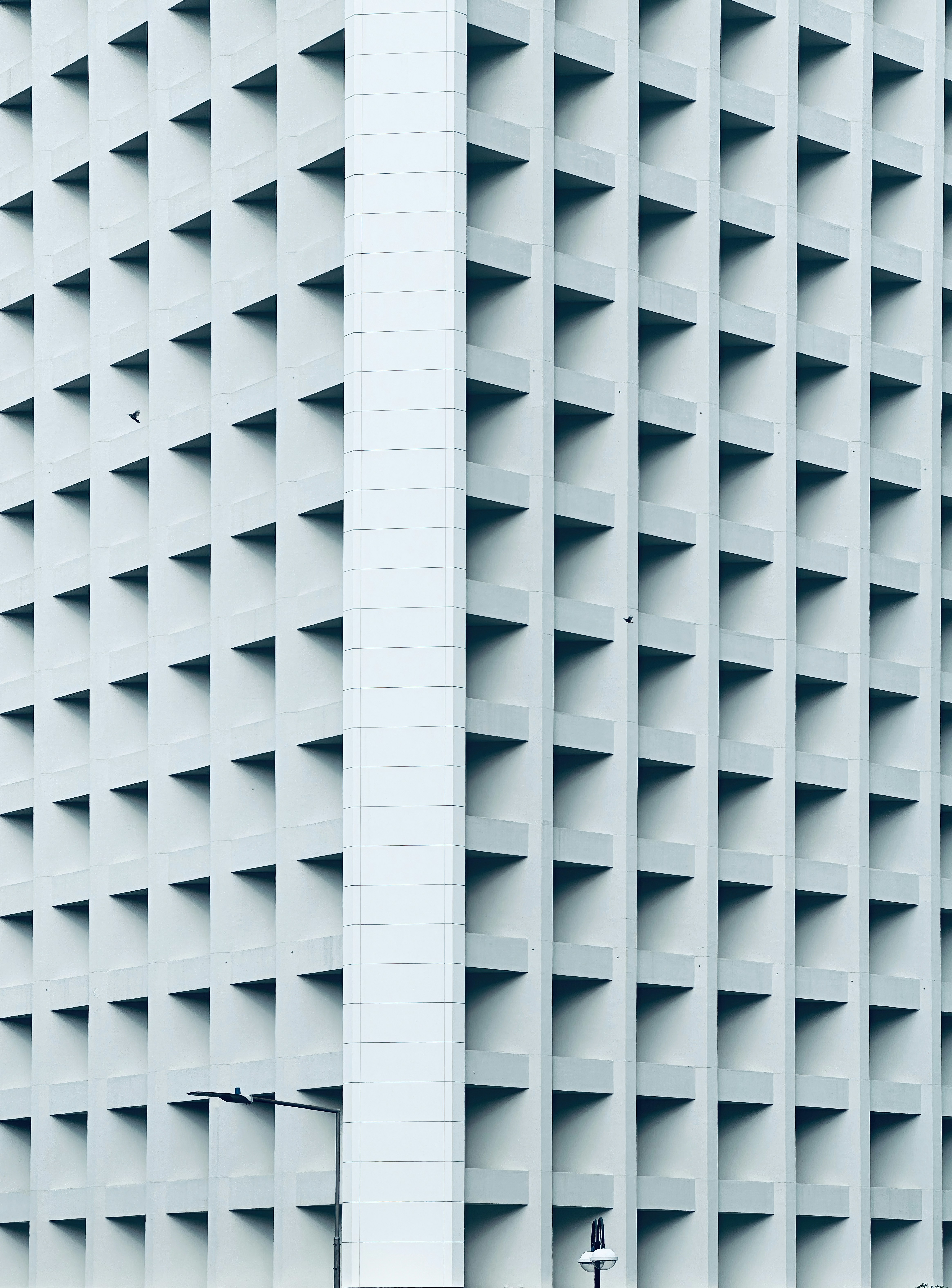 a tall white building with a clock on it's side