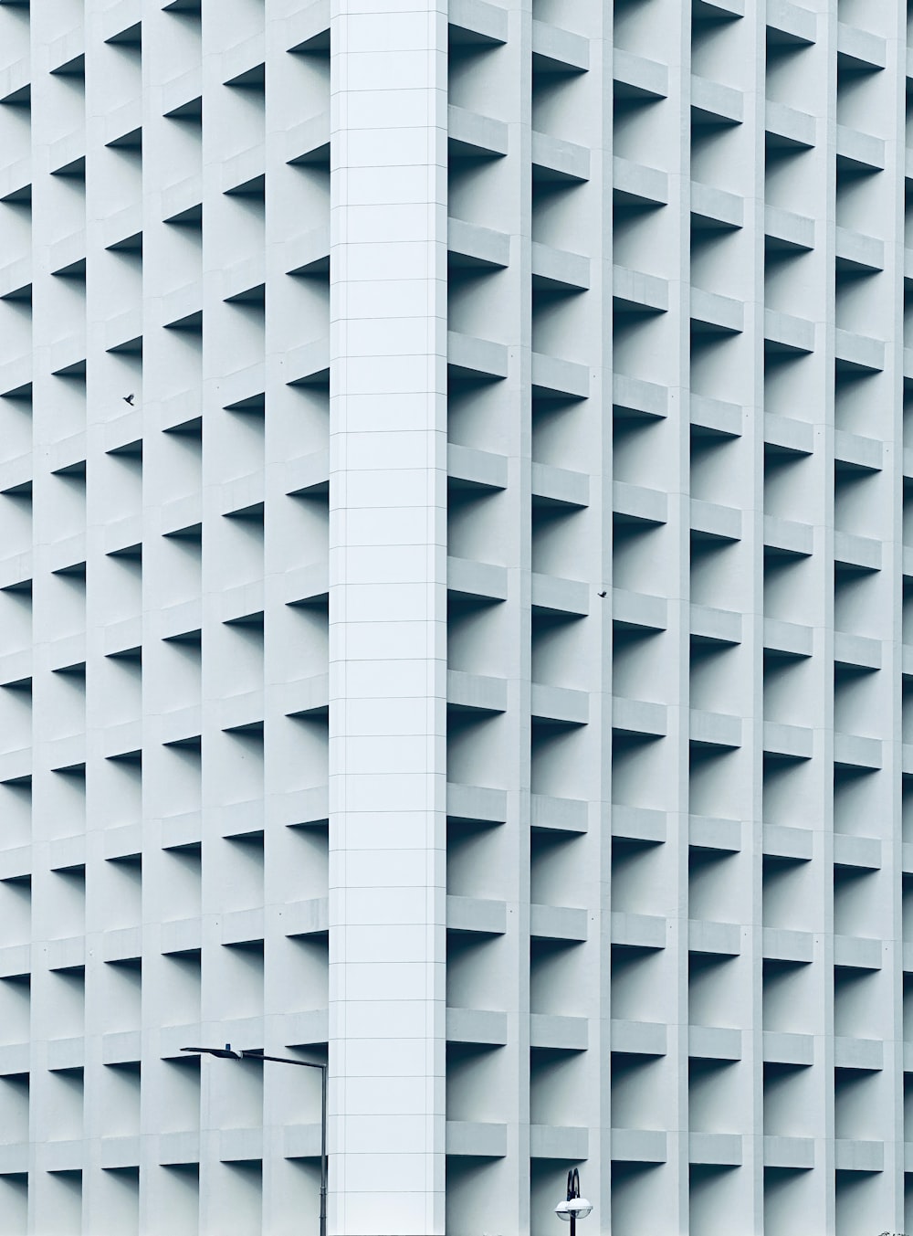 a tall white building with a clock on it's side