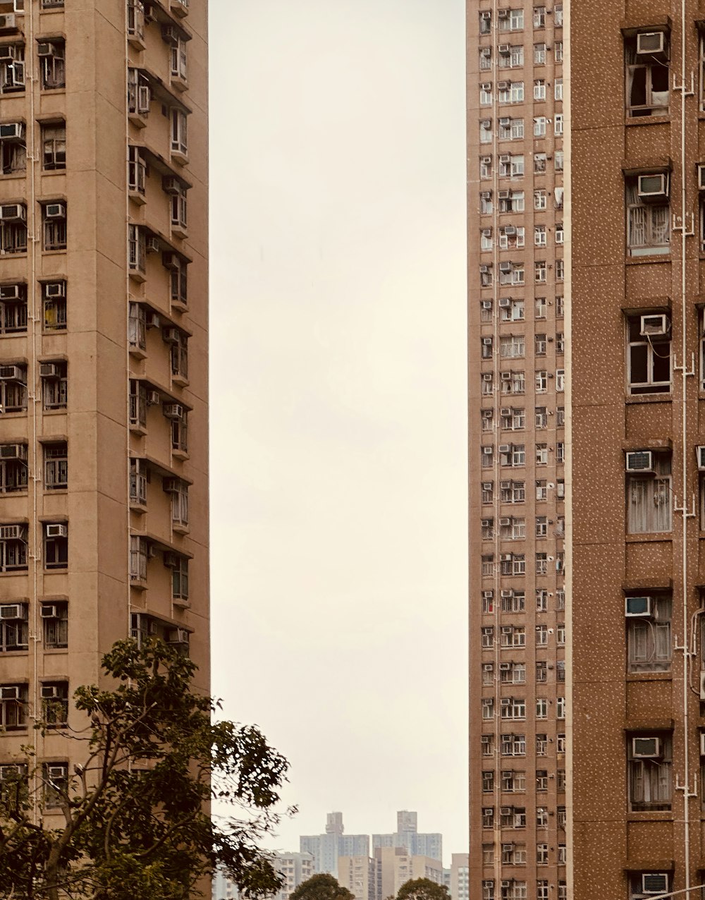 a couple of tall buildings sitting next to each other