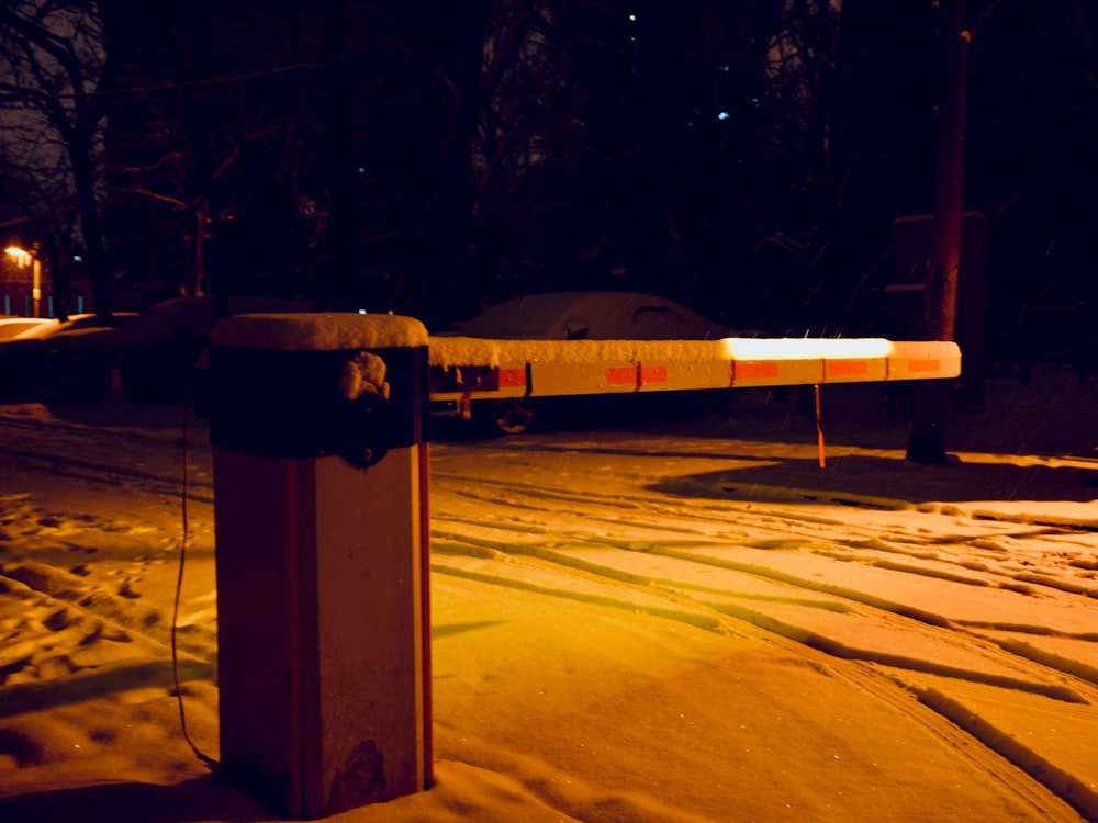 a parking meter in the snow at night
