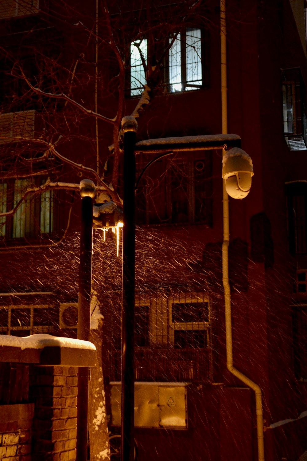 a snow covered street light next to a building